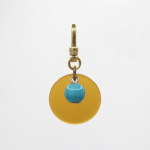 Sun & Moon Saffron Translucent Bakelite with Turquoise Glass Bead Dua Charm