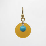 Sun & Moon Saffron Translucent Bakelite with Turquoise Glass Bead Dua Charm