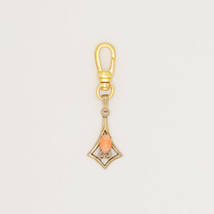 Articulated geometric charm with coral cabochon