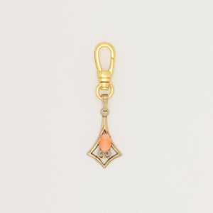 Articulated geometric charm with coral cabochon