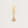 Articulated geometric charm with coral cabochon
