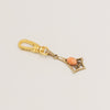 Articulated geometric charm with coral cabochon